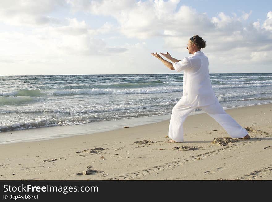 Man Posing on Sea Shore during Daytime