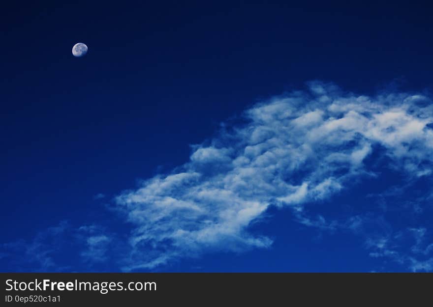 White Clouds Under Blue Sky With Gibbous Moon