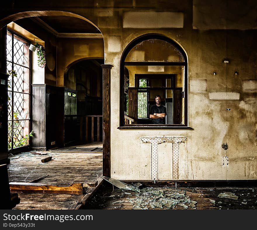 Person Standing Behind Black Wooden Window