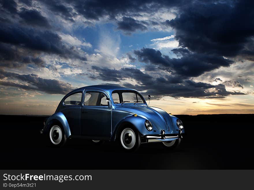 Blue Volkswagen Beetle Under Blue Sky and White Clouds during Golden Hour