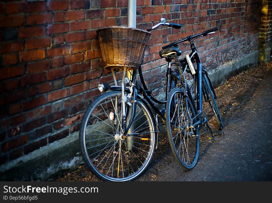 Bicycles leaning against brick wall in alley. Bicycles leaning against brick wall in alley.