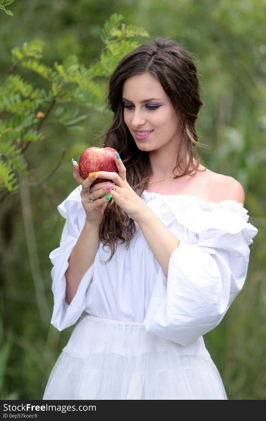 Woman Wearing White Off Shoulder Top Holding Red Apple Fruit