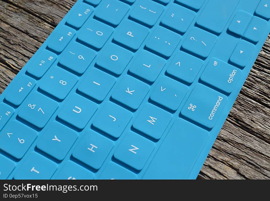 Blue Computer Keyboard on Gray Wooden Surface