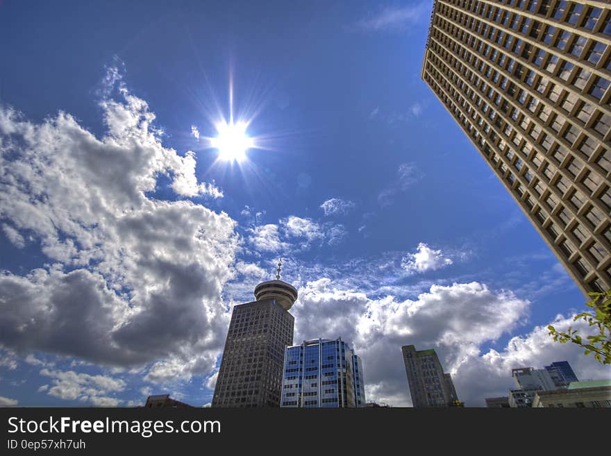 Low Angle Photography of Skyscrapers Under White and Gray Cloudy Blue Sky at Daytime