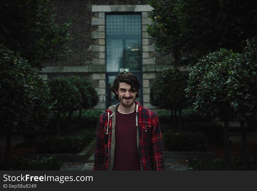 Outdoor portrait of man standing with a grimace.