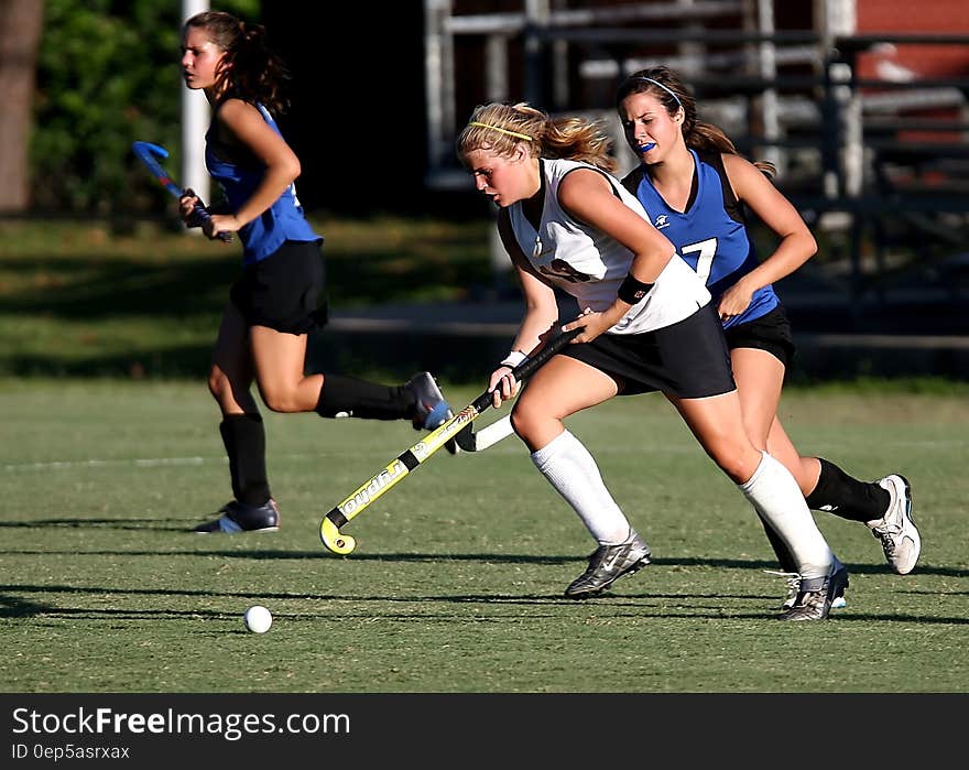 Group of Woman Playing on Green Field during Daytime