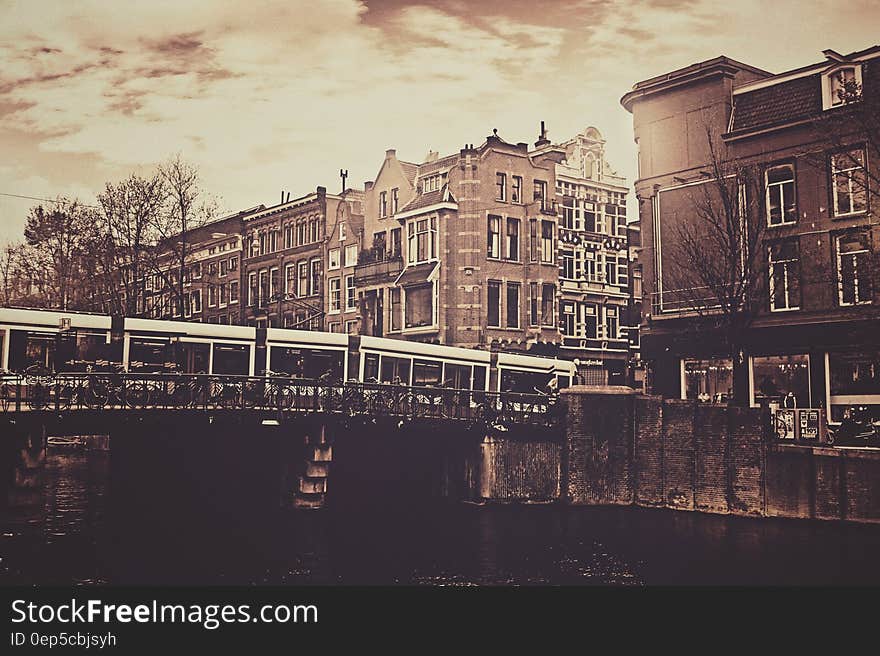 Sepia Photography of Bridge and Concrete House