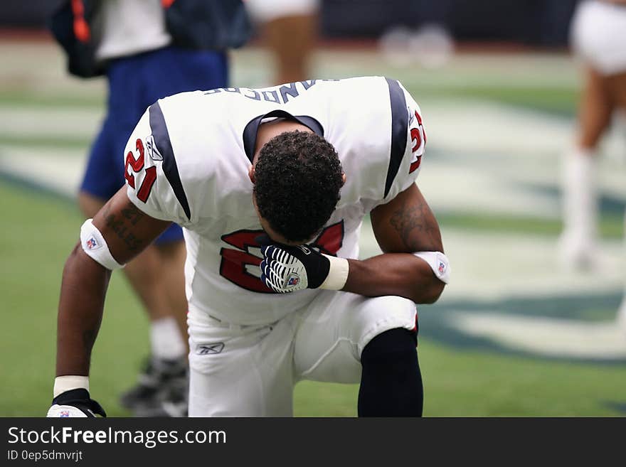 Football Player on Bended Knees