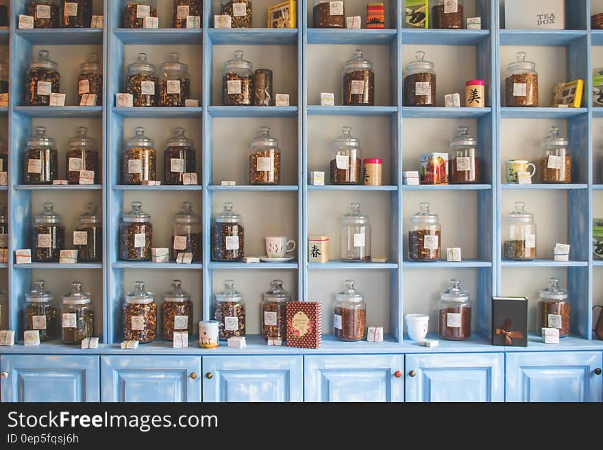 Assorted Jars on Blue Shelf Cabinets