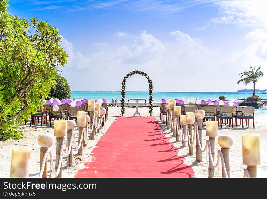 Beach Wedding Event Under White Clouds and Clear Sky during Daytime