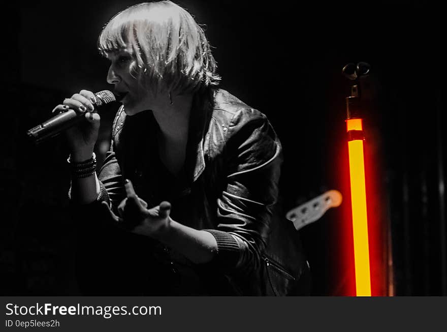 Rock Band Lead Singer Wearing Black Jacket and Wireless Microphone