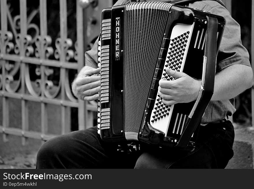 Person Playing a Horner Musical Intrument in Grayscale