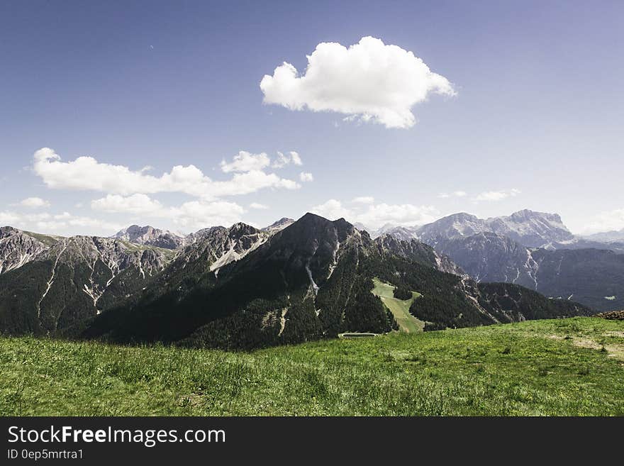 Mountains Under Cloudy Sky during Daytime