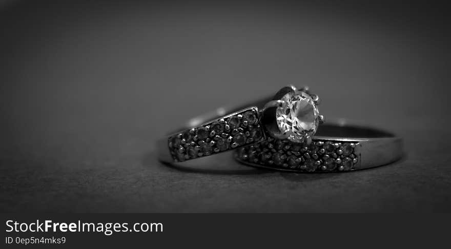 Grayscale Photo of 2 Silver With Diamond Rings