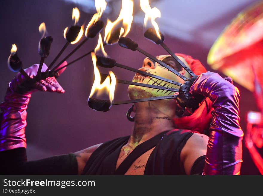 Red Haired Fire Dancer Blowing Rod With Flames