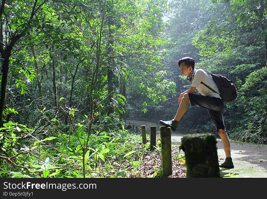 Boy Standing in Black Backpack Standing Near the Fence