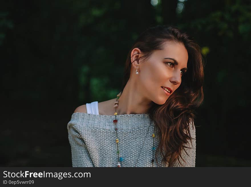 Woman in Grey Off Shoulder Sweater Staring in the Left Side of View