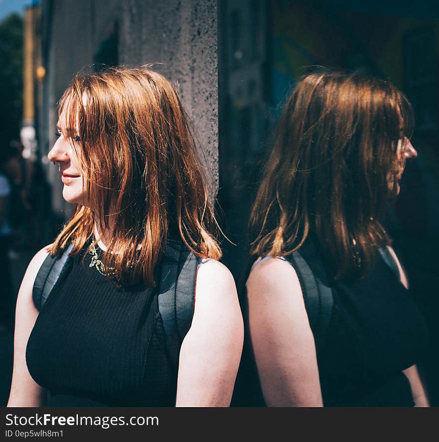 Woman in Black Sleeveless Top Wearing Black Backpack