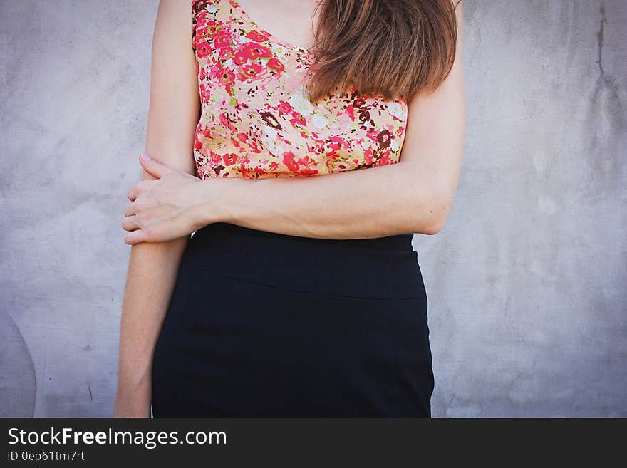 Woman Wearing Red and Green Sleeveless Shirt and Black Bottoms