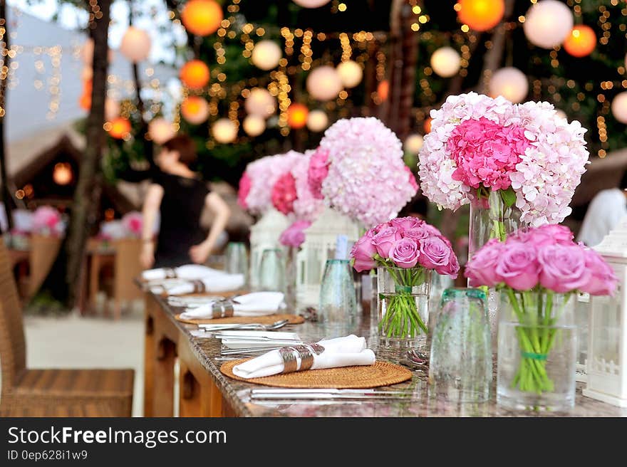 Table With Plates and Flowers Filed Neatly Selective Focus Photography