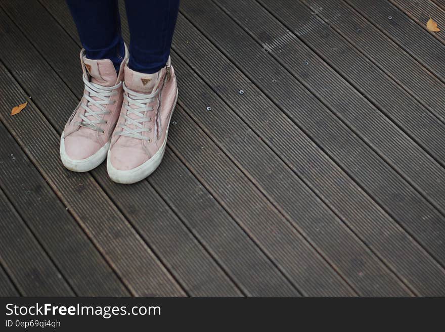 Person Wearing Pink and White High Top Sneakers