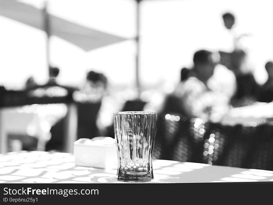 Clear Cut Glass Highball Drinking Glass at the Top of the Table Selective Focus Photography