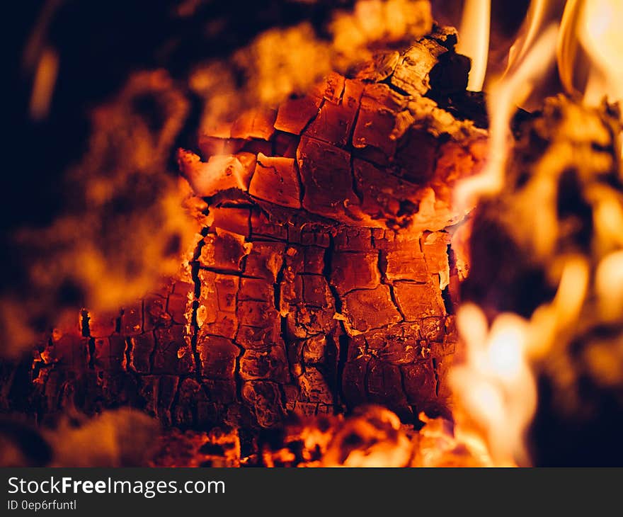 Background of fire with burning log beginning to disintegrate into small square glowing pieces, hot orange and white flames everywhere. Background of fire with burning log beginning to disintegrate into small square glowing pieces, hot orange and white flames everywhere.