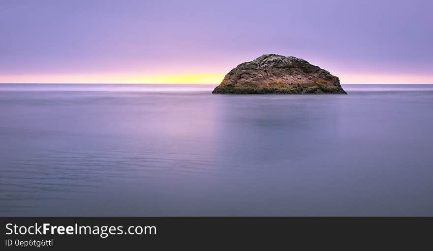 Photo of Island on Sea during Sunset