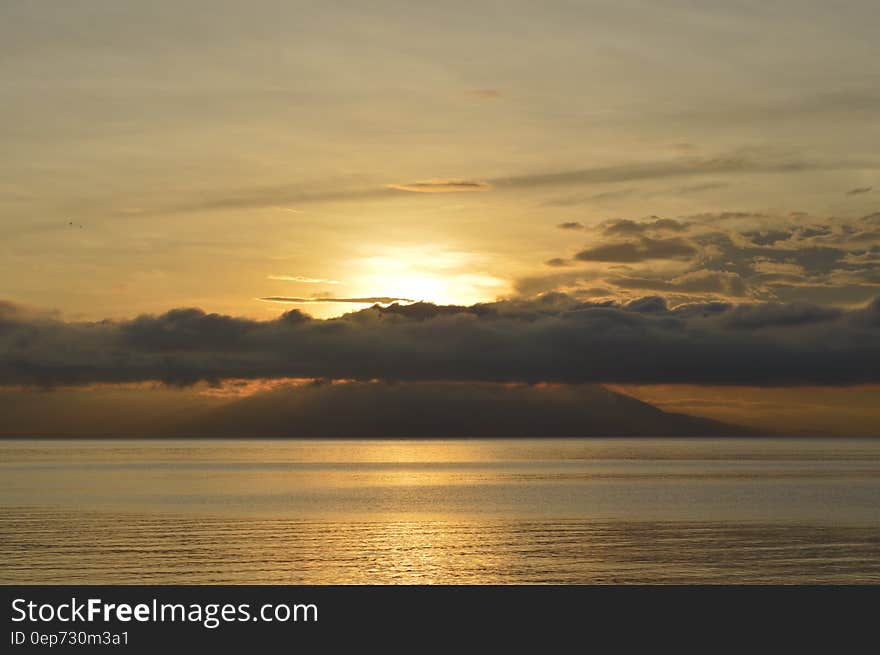 Clouds Above Calm Sea during Sunset