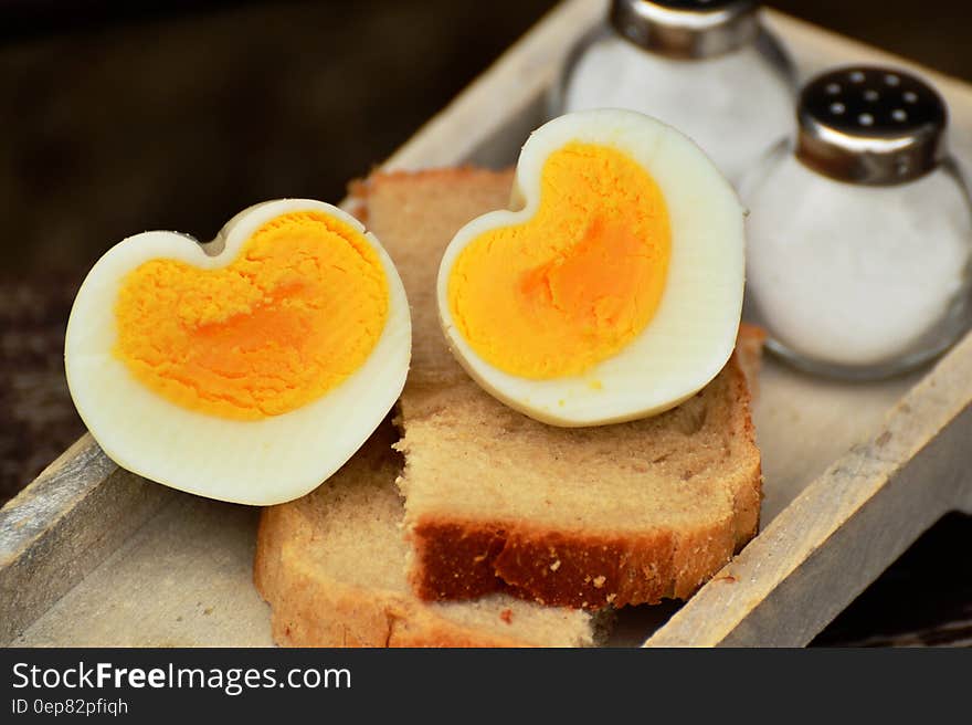 Boiled Egg on Top on Bread Beside Salt Shaker