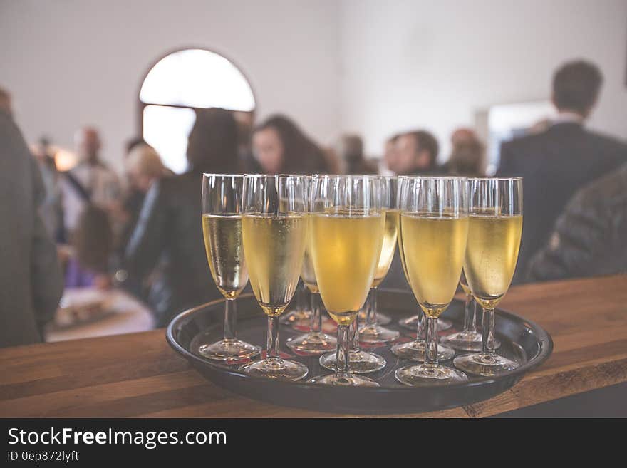 Glasses of champagne or sparkling wine on a serving tray at the bar. Glasses of champagne or sparkling wine on a serving tray at the bar.