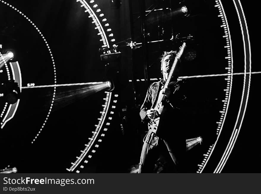 Greyscale Photography of Man Playing Guitar