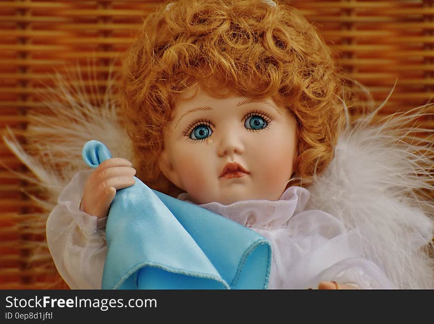 Girl Doll in White Fur Dress Holding Blue Handkerchief