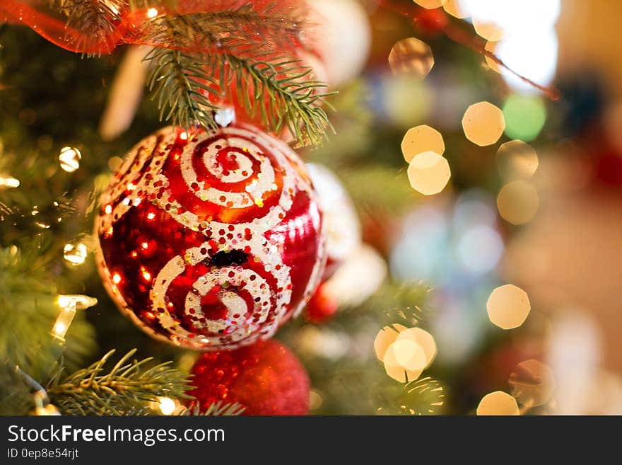 A decorated Christmas tree with red baubles and lights.