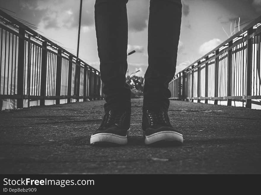 Person in Black Skinny Jeans Standing at the Center of Road