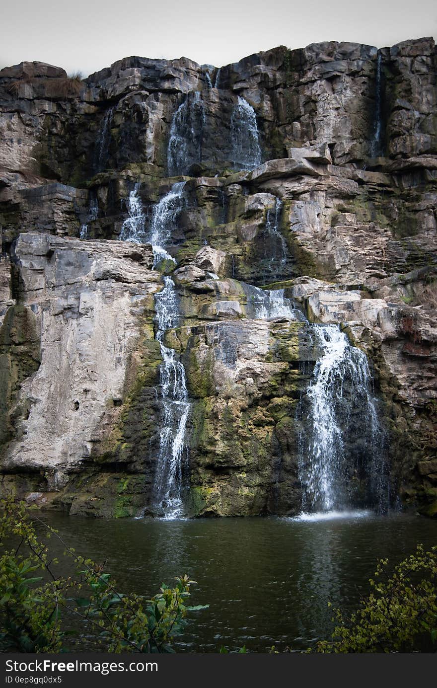 Timelaps Photo of White Green and Black Rock Falls during Daytime