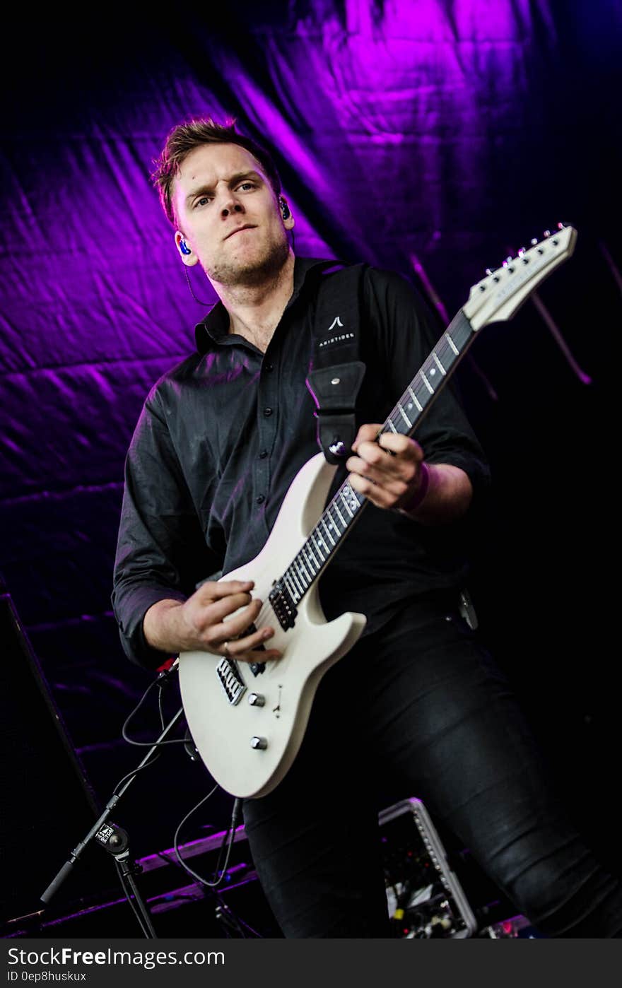 Man in Black Dress Shirt Playing Guitar