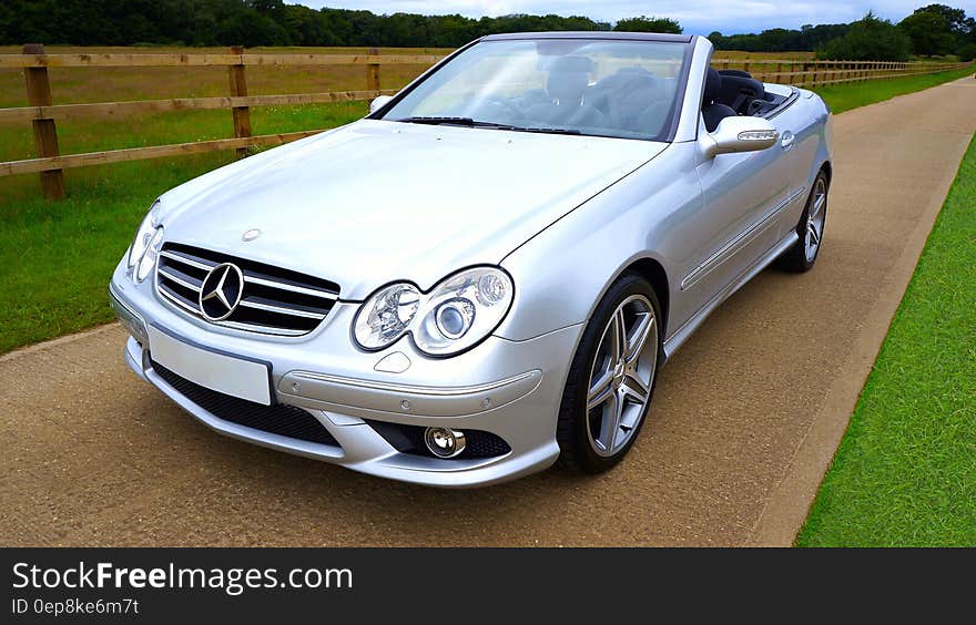 Silver Mercedez Benz Convertible on Brown Concrete Road