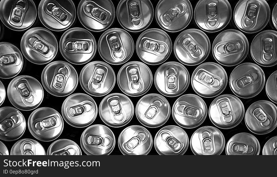 Tops of aluminum cans in black and white.