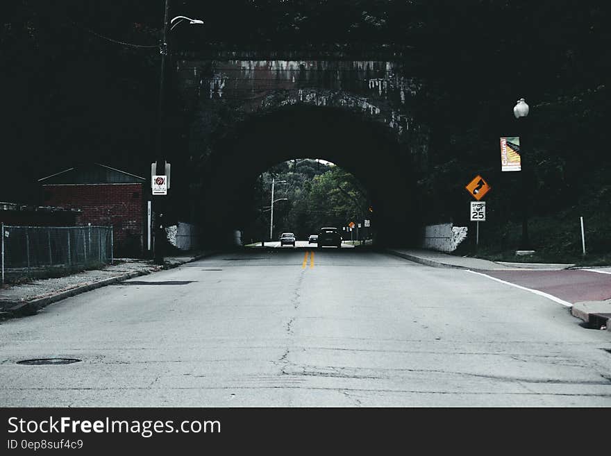 Cars on Road Under Tunnel during Daytime