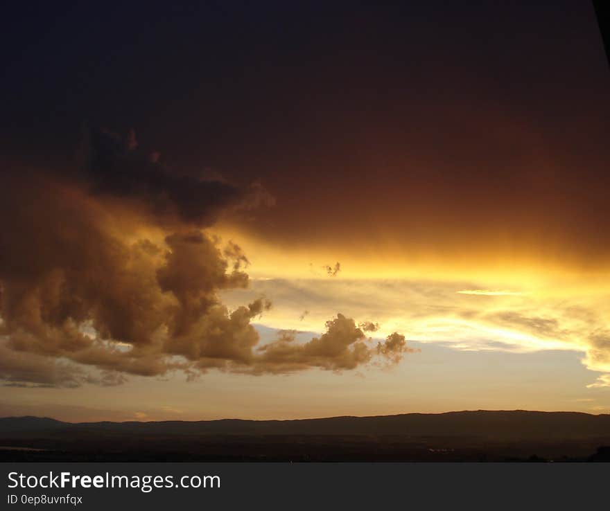 Black Yellow and White Clouds