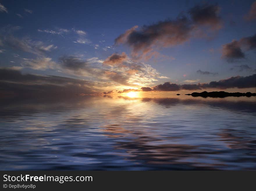 Sea Near Island during Sunset