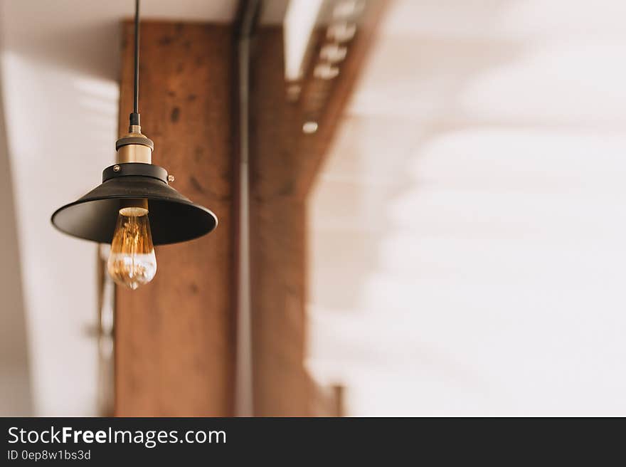 Shallow Focus Photography of Black and Orange Pendant Lamp