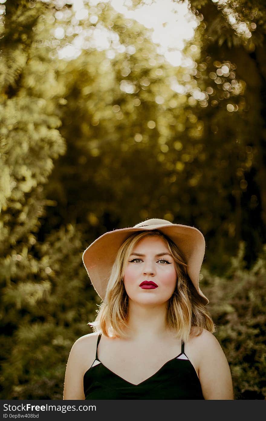 Woman in Black Dress Wearing Sunhat during Daytime