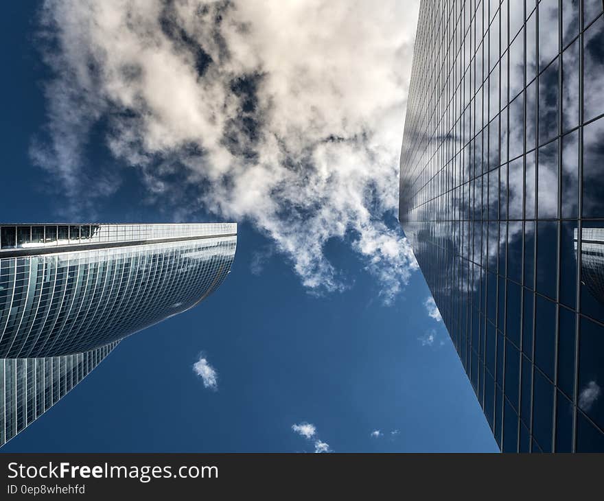 Worm&#x27;s Eye View of High Rise Building Under White Cloudy Sky