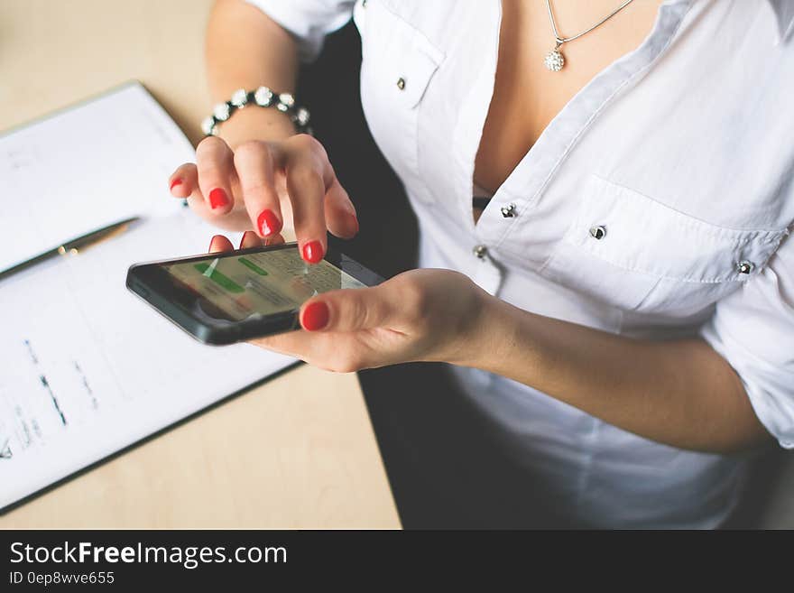 Woman in White Button Up Top and Holding Black Android Smartphone