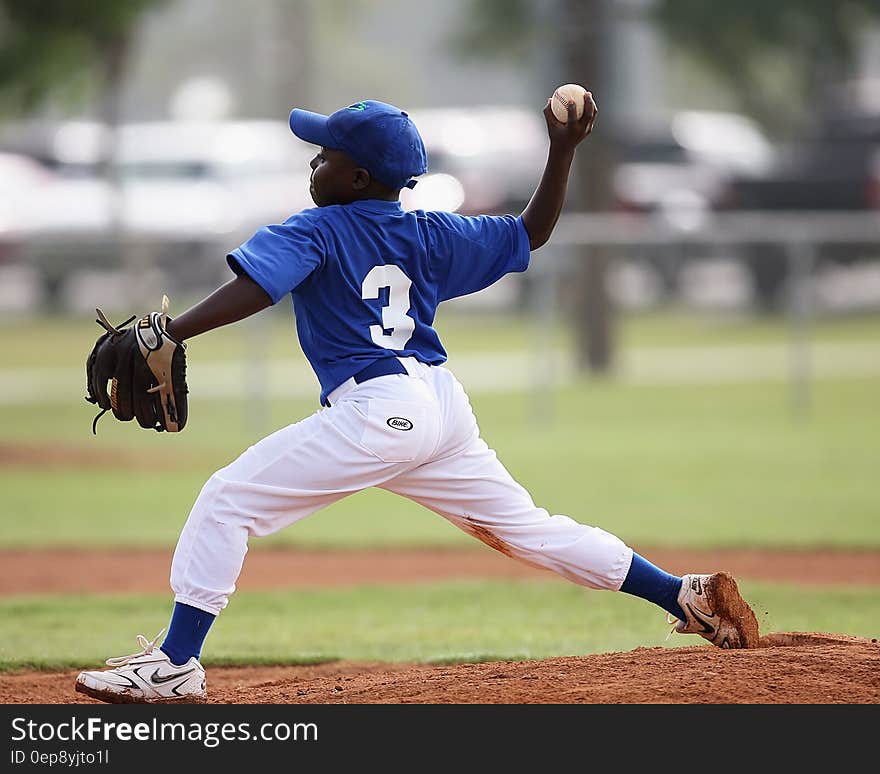 Boy Wearing Blue and White 3 Jersey About to Pitch a Baseball