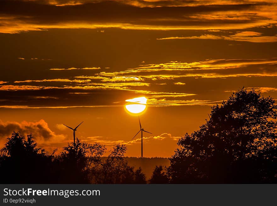 Wind turbines in country field at sunset. Wind turbines in country field at sunset.