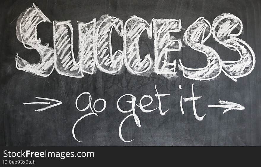 Success, go get it, in white chalk on blackboard. Success, go get it, in white chalk on blackboard.