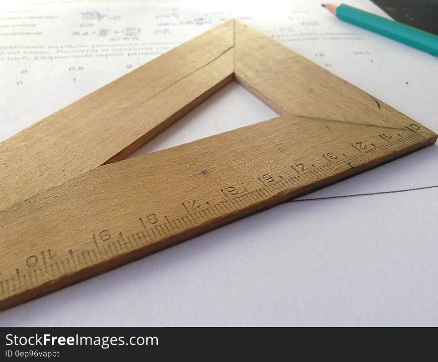 Still life of geometry homework sheet with wooden measuring stick and pencil.